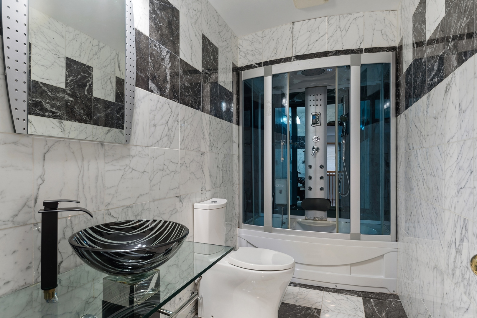 1115 South Elmhurst Road Wheeling, IL 60090 - Photo 22 of 33 a bathroom with a toilet a sink and a shower