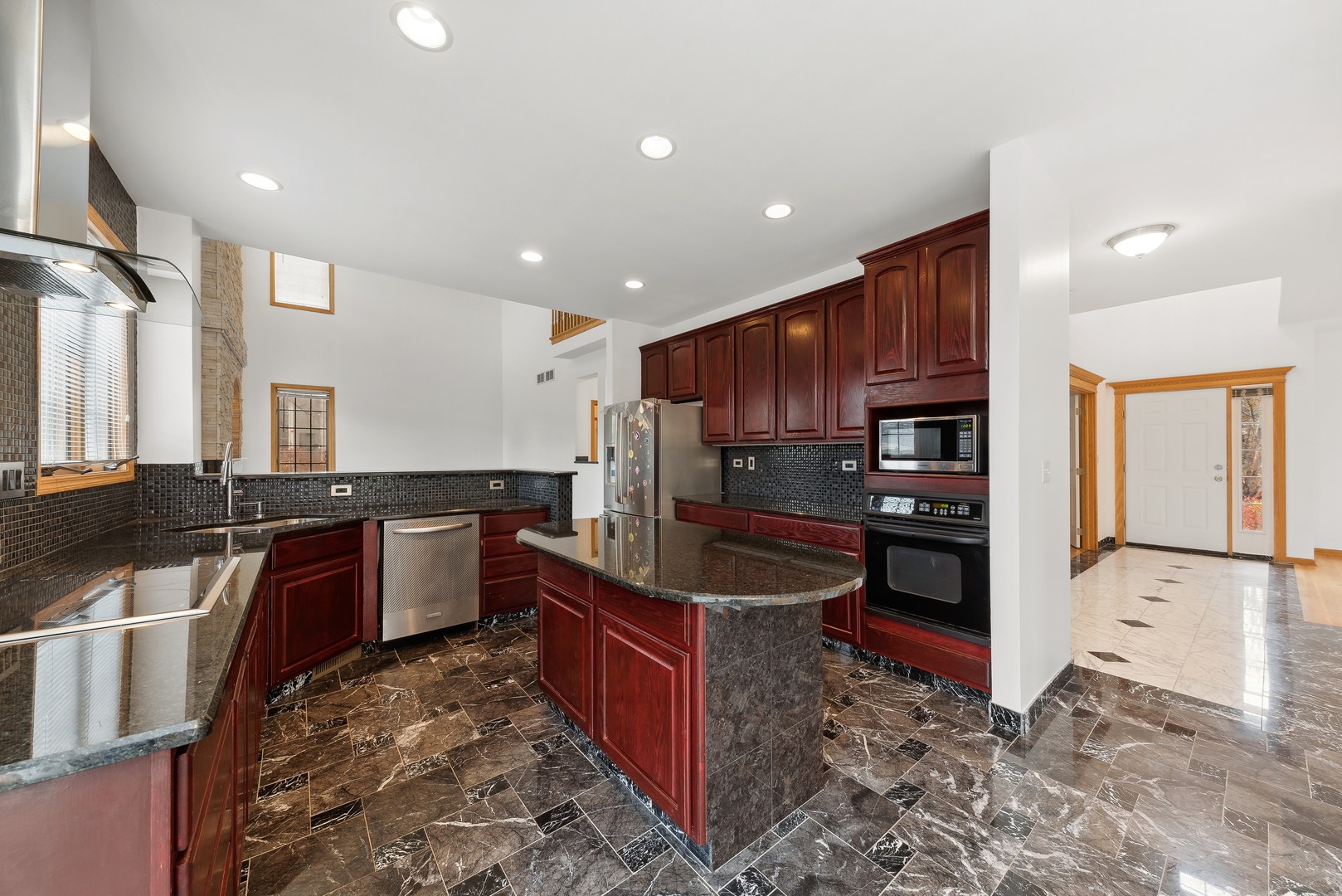 1115 South Elmhurst Road Wheeling, IL 60090 - Photo 4 of 33 a kitchen with stainless steel appliances granite countertop a stove refrigerator sink and cabinets