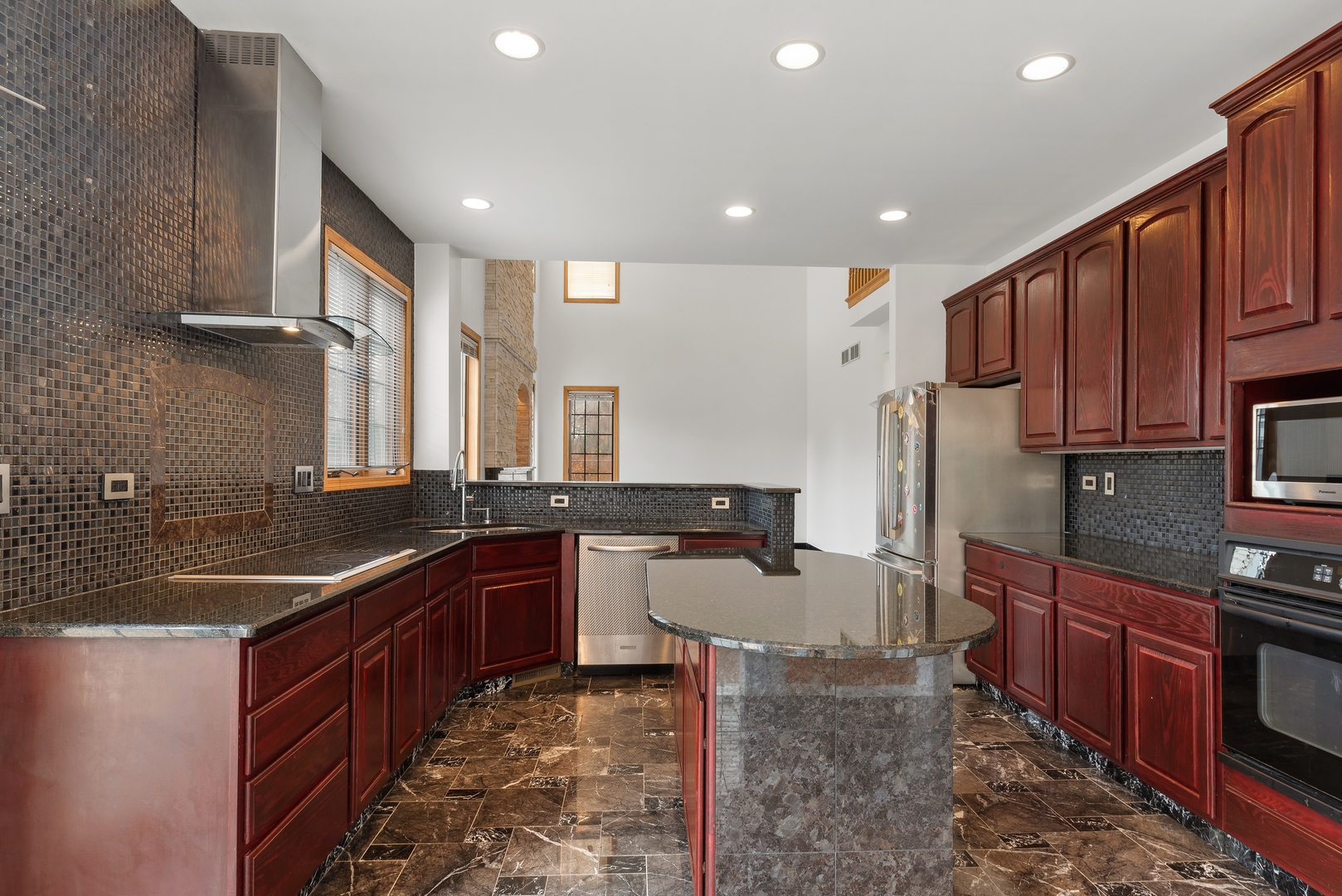1115 South Elmhurst Road Wheeling, IL 60090 - Photo 5 of 33 a kitchen with stainless steel appliances granite countertop a sink stove and refrigerator