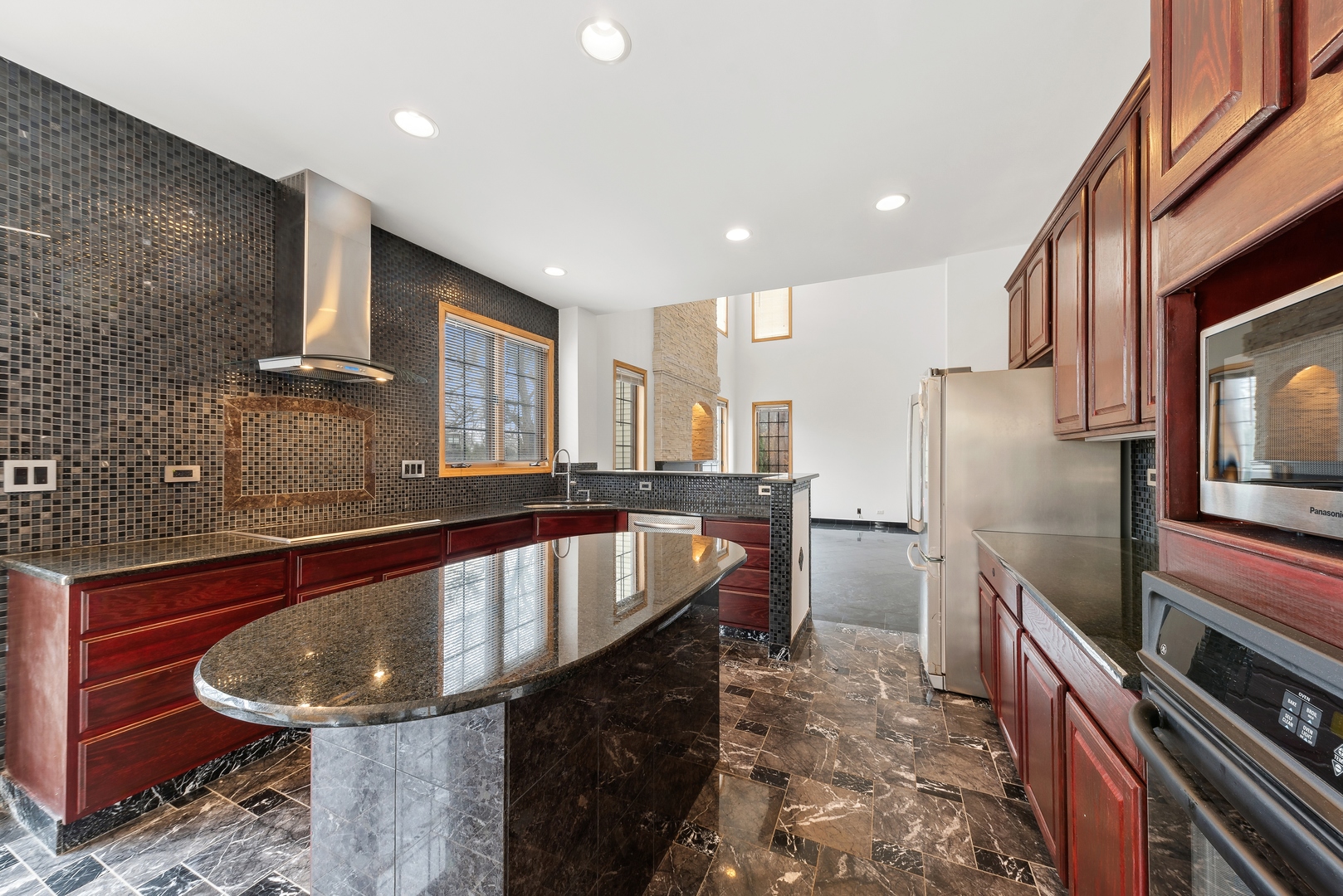 1115 South Elmhurst Road Wheeling, IL 60090 - Photo 6 of 33 a kitchen with stainless steel appliances granite countertop a sink a stove and a refrigerator