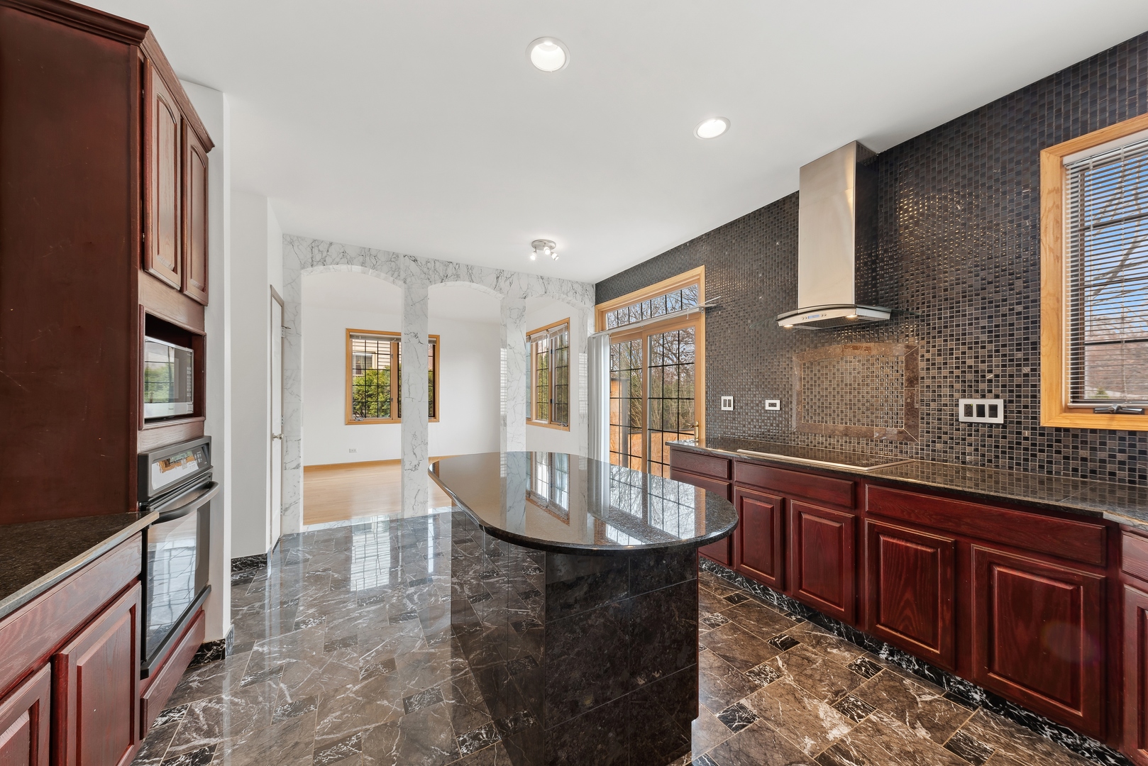 1115 South Elmhurst Road Wheeling, IL 60090 - Photo 7 of 33 a large kitchen with kitchen island granite countertop a sink and dishwasher wooden cabinets with granite countertops