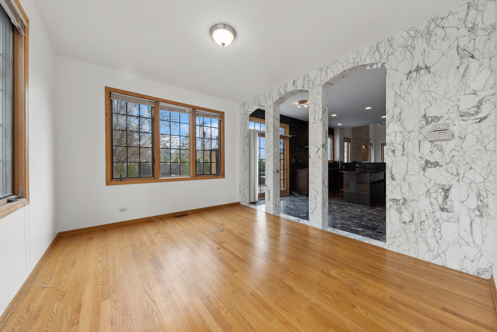 1115 South Elmhurst Road Wheeling, IL 60090 - Photo 9 of 33 wooden floor in an empty room with a fireplace