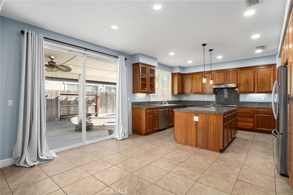 2010 Jacob Street Gridley, CA 95948 - Photo 14 of 63 a large kitchen with kitchen island granite countertop a large counter top and stainless steel appliances