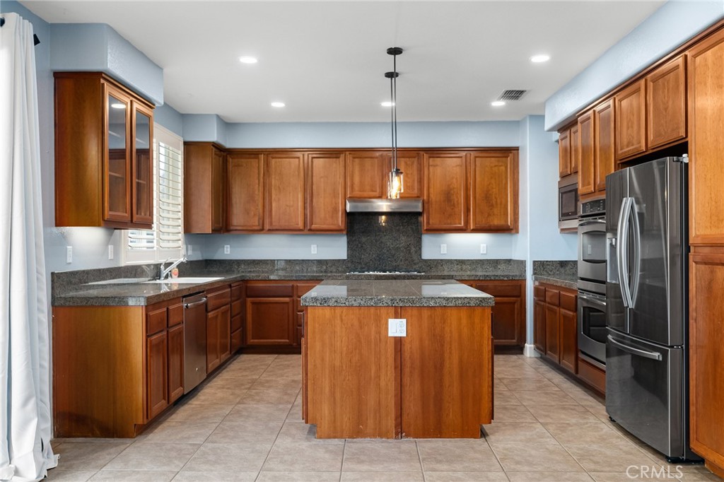 2010 Jacob Street Gridley, CA 95948 - Photo 15 of 63 a kitchen with stainless steel appliances granite countertop wooden cabinets a sink dishwasher a refrigerator and a stove