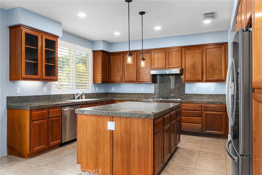 2010 Jacob Street Gridley, CA 95948 - Photo 16 of 63 a kitchen with stainless steel appliances granite countertop wooden cabinets a sink and a oven