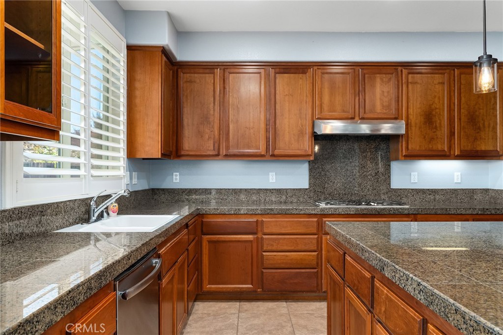 2010 Jacob Street Gridley, CA 95948 - Photo 18 of 63 a kitchen with granite countertop a sink a stove and cabinets