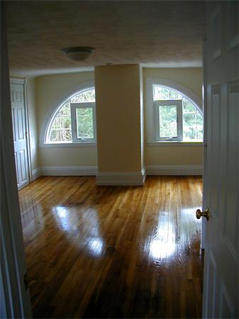 49 Dean Avenue, Unit 2 Franklin, MA 02038 - Photo 7 of 9 a view of empty room with wooden floor and fan