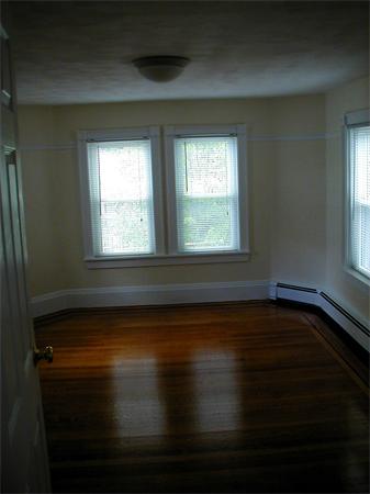 49 Dean Avenue, Unit 2 Franklin, MA 02038 - Photo 8 of 9 a view of an empty room with wooden floor and a window
