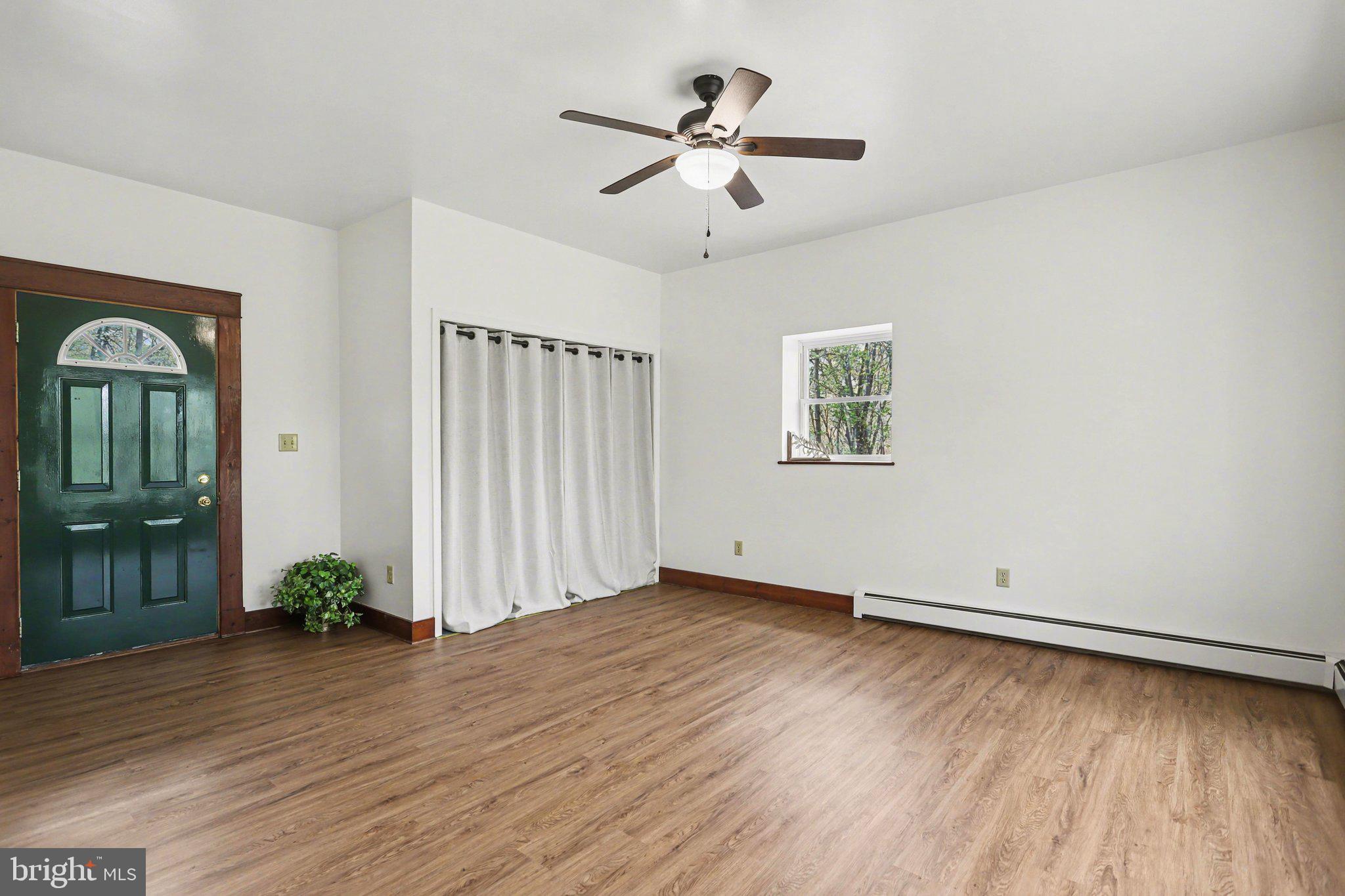204 Bullfrog Road Gettysburg, PA 17325 - Photo 24 of 52 an empty room with wooden floor and windows