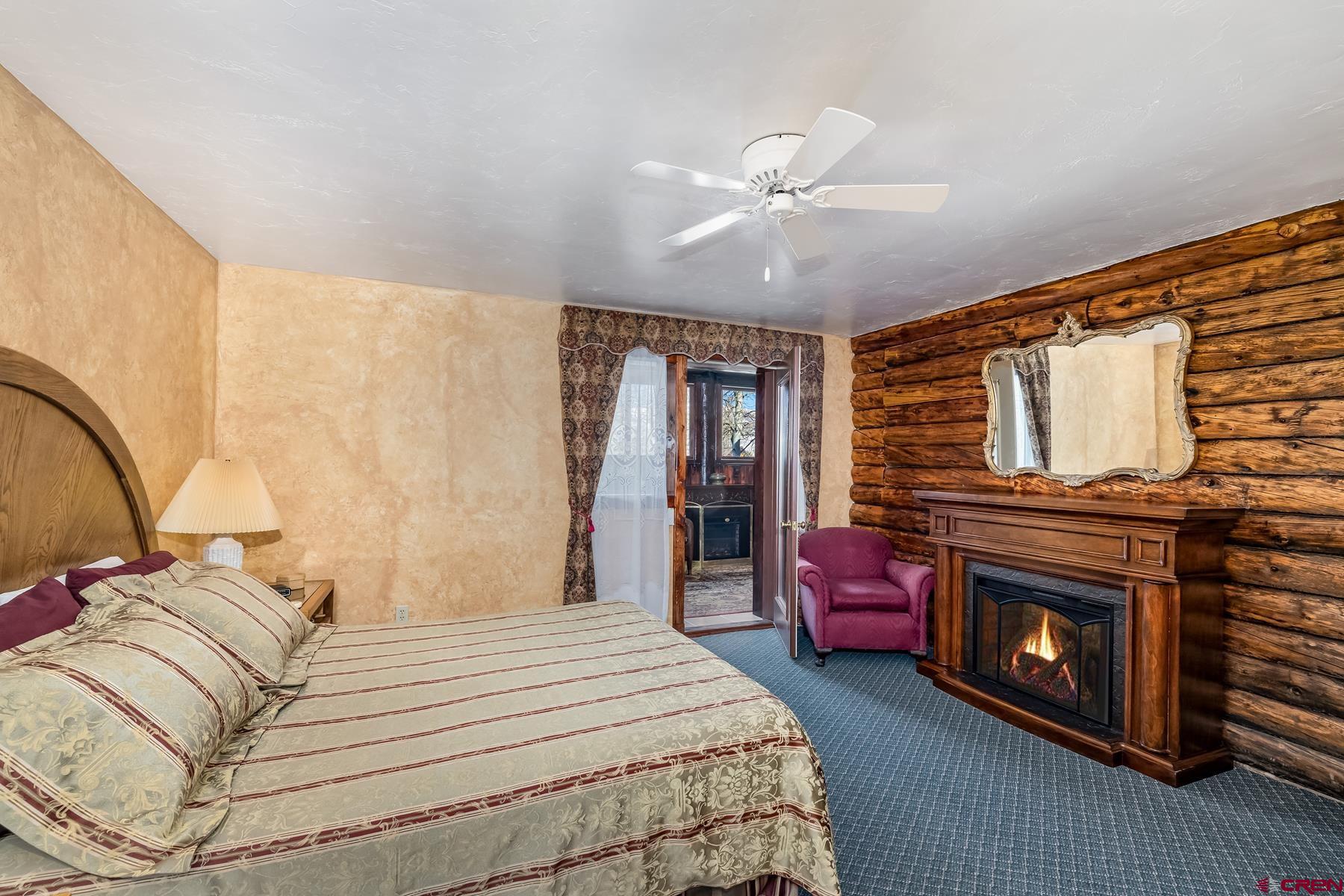8 Gothic Avenue Crested Butte, CO 81224 - Photo 26 of 35 a bedroom with a bed and a fireplace