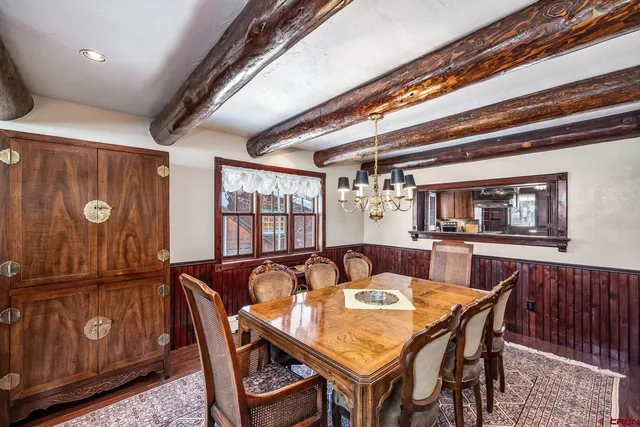 a dining room with furniture window and wooden floor