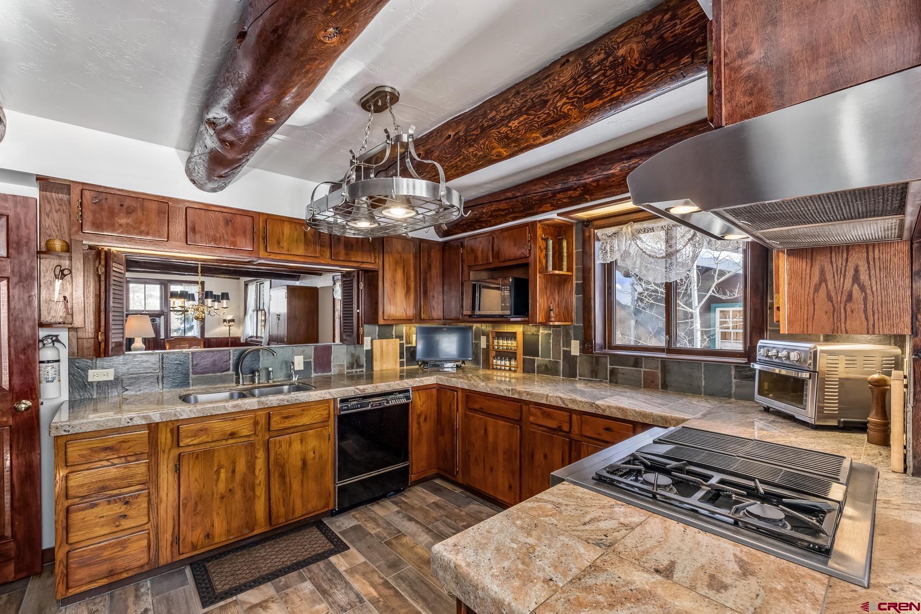 8 Gothic Avenue Crested Butte, CO 81224 - Photo 8 of 35 a kitchen with a stove a sink and a refrigerator