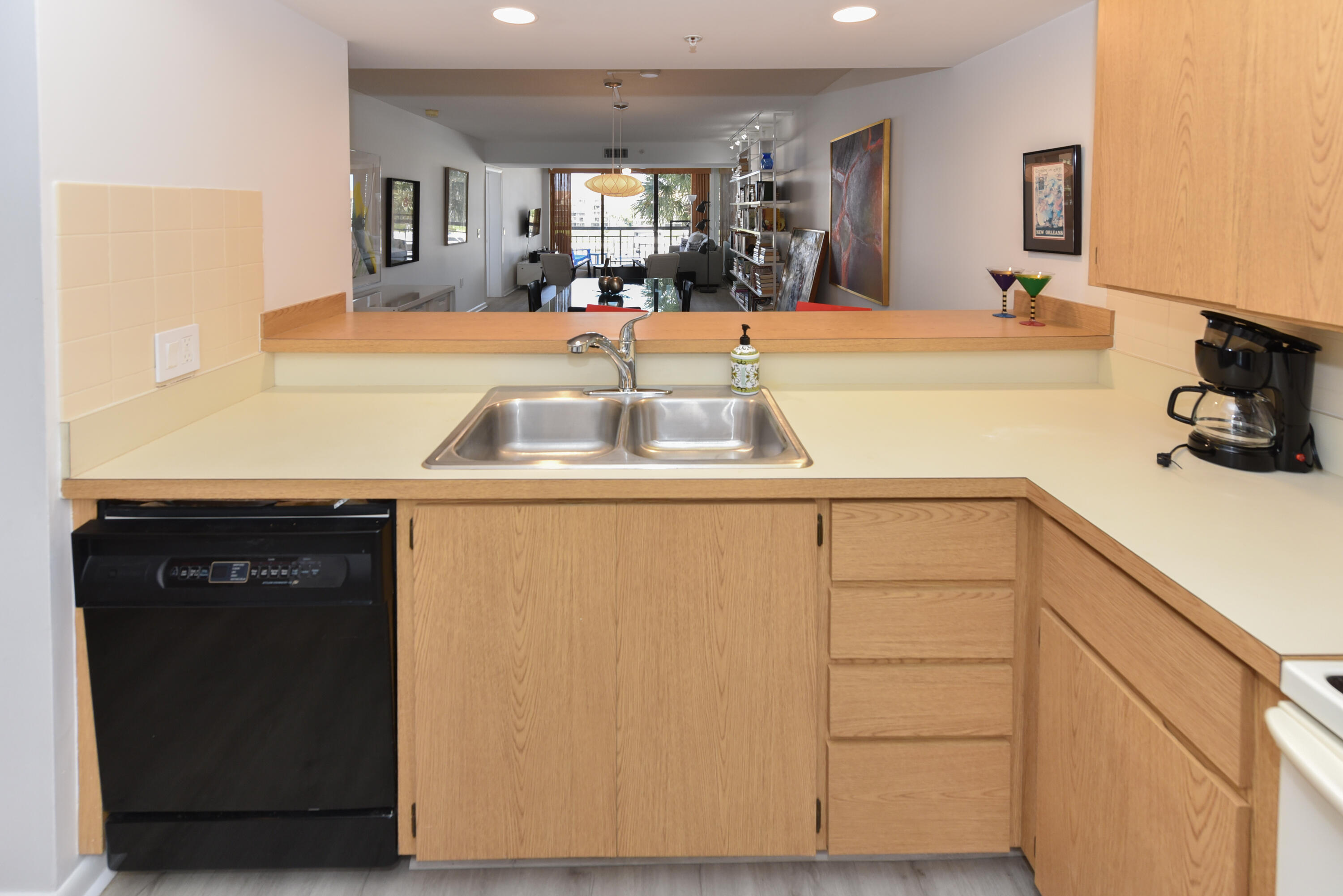 2401 Marina Isle Way, Unit 405 Jupiter, FL 33477 - Photo 13 of 30 a kitchen with a sink and a refrigerator