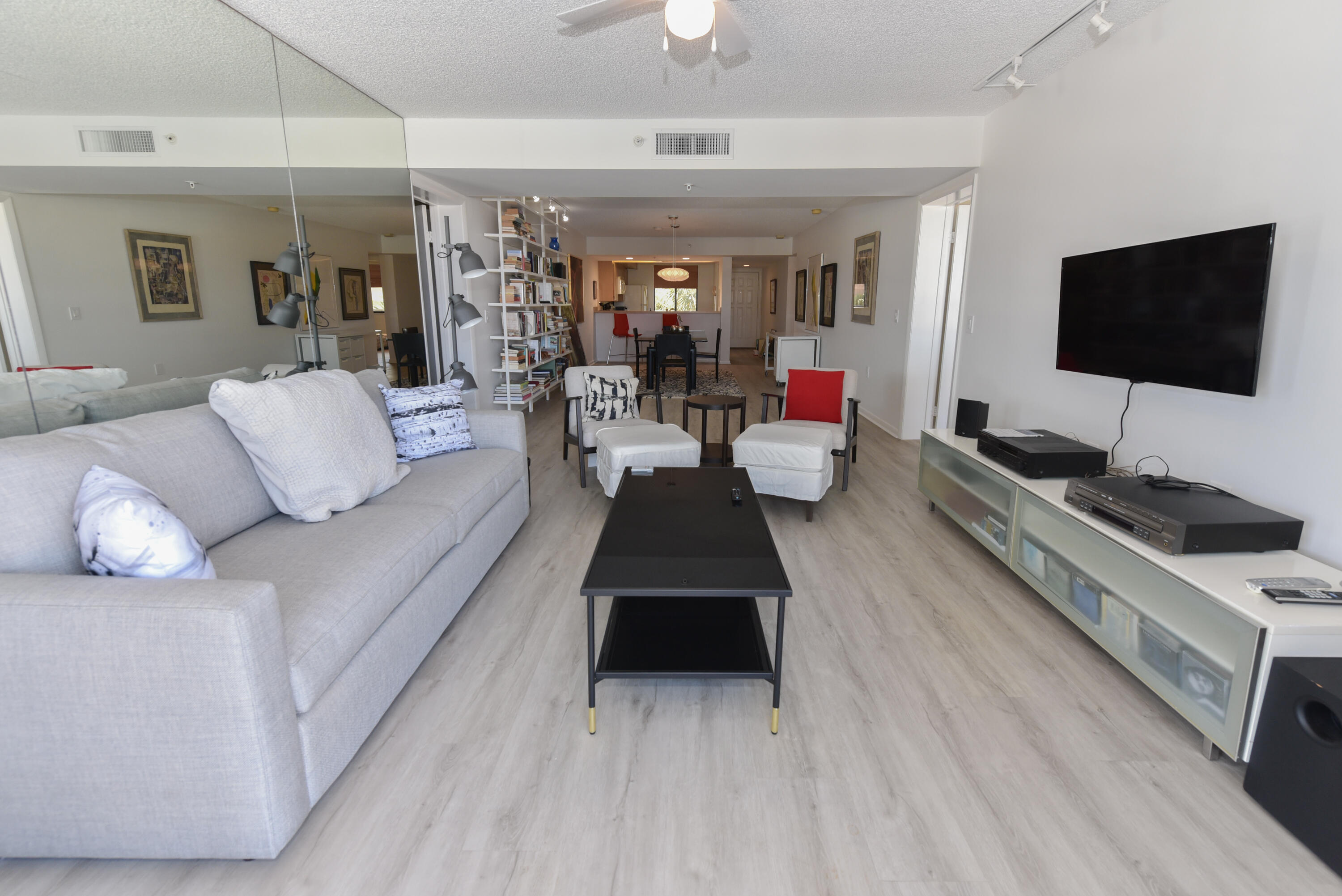 2401 Marina Isle Way, Unit 405 Jupiter, FL 33477 - Photo 18 of 30 a living room with furniture and a flat screen tv