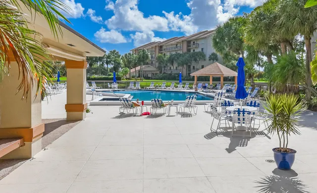 a view of a patio with swimming pool table and chairs