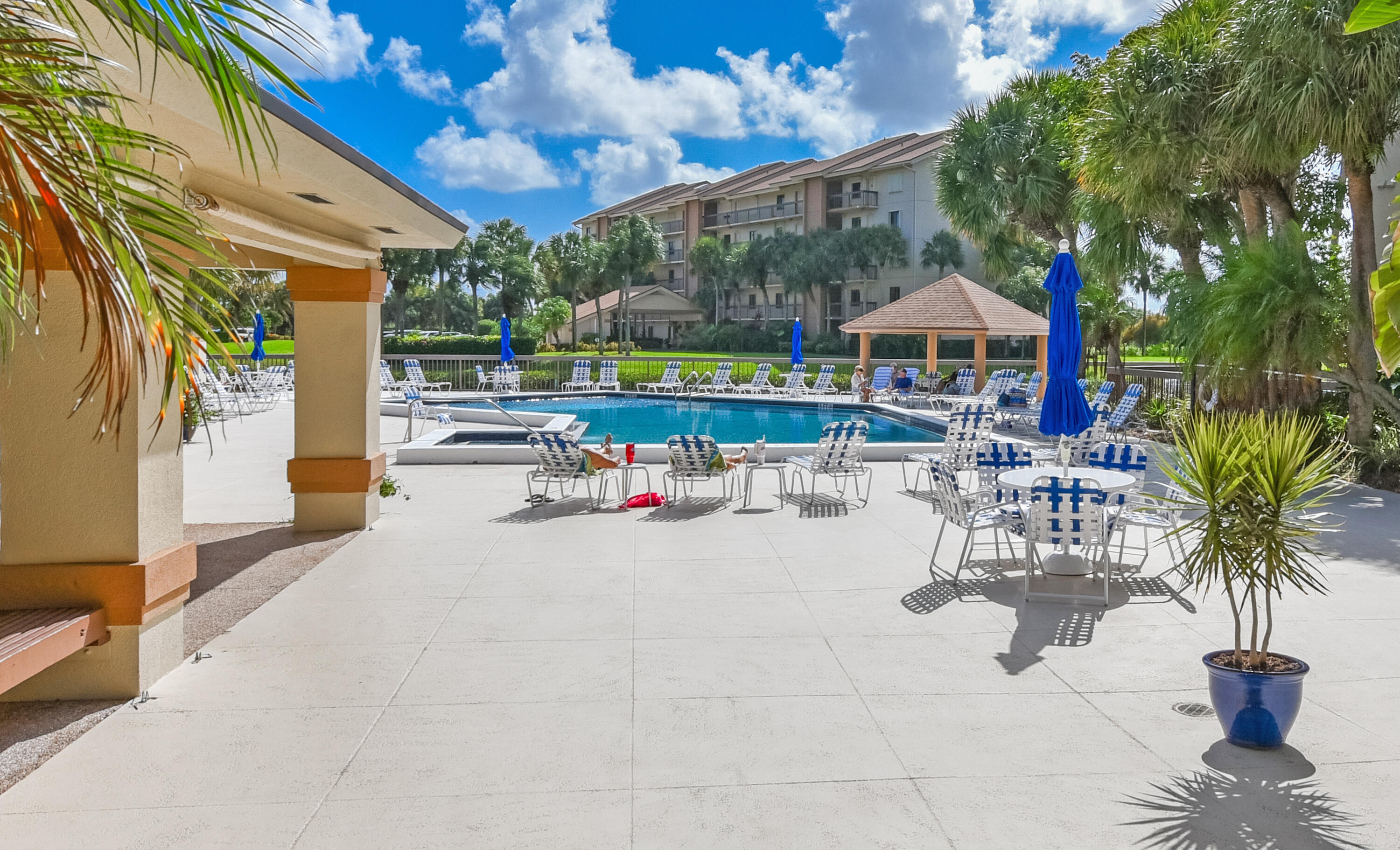 2401 Marina Isle Way, Unit 405 Jupiter, FL 33477 - Photo 29 of 30 a view of a patio with swimming pool table and chairs