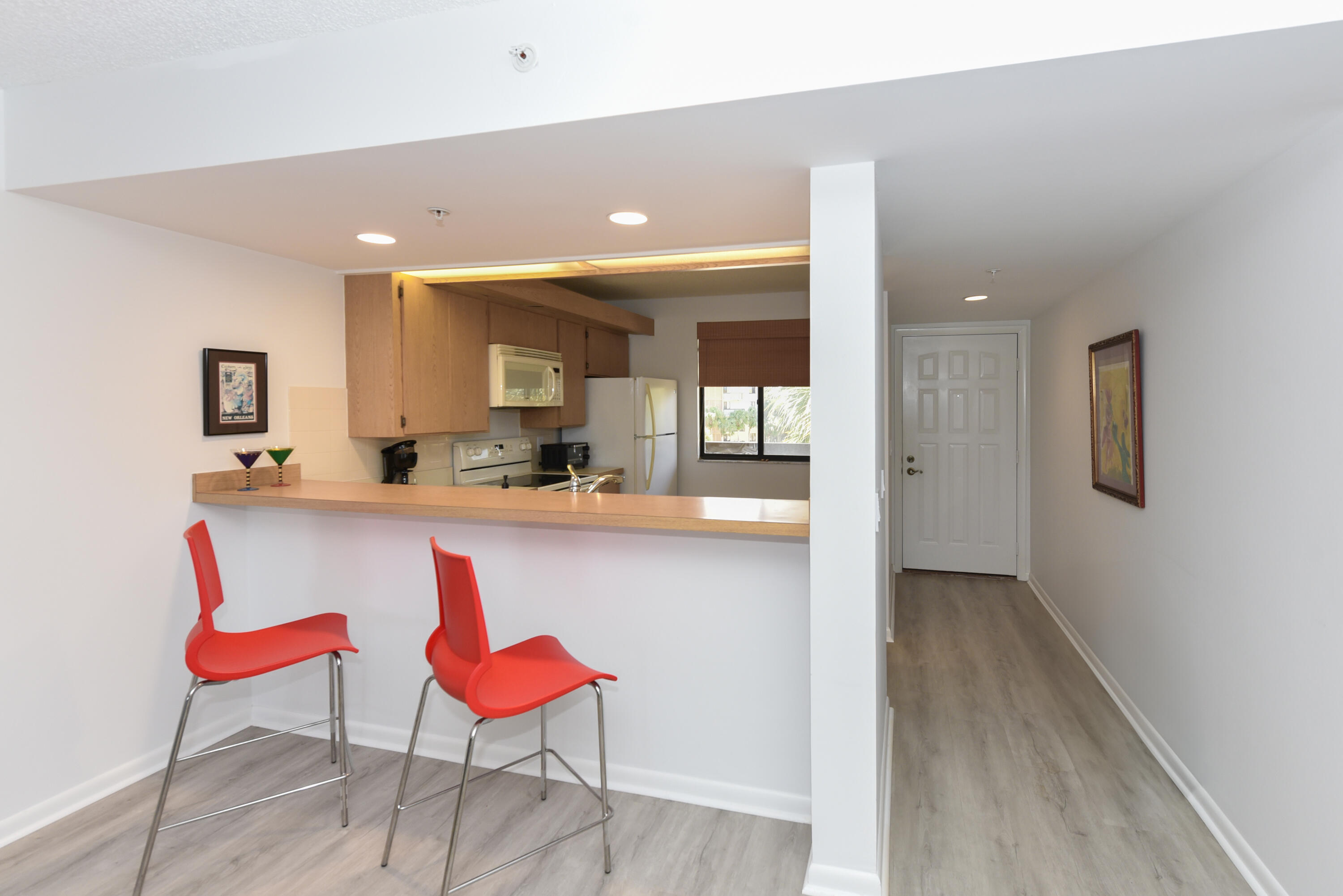 2401 Marina Isle Way, Unit 405 Jupiter, FL 33477 - Photo 9 of 30 a kitchen with a sink and chairs