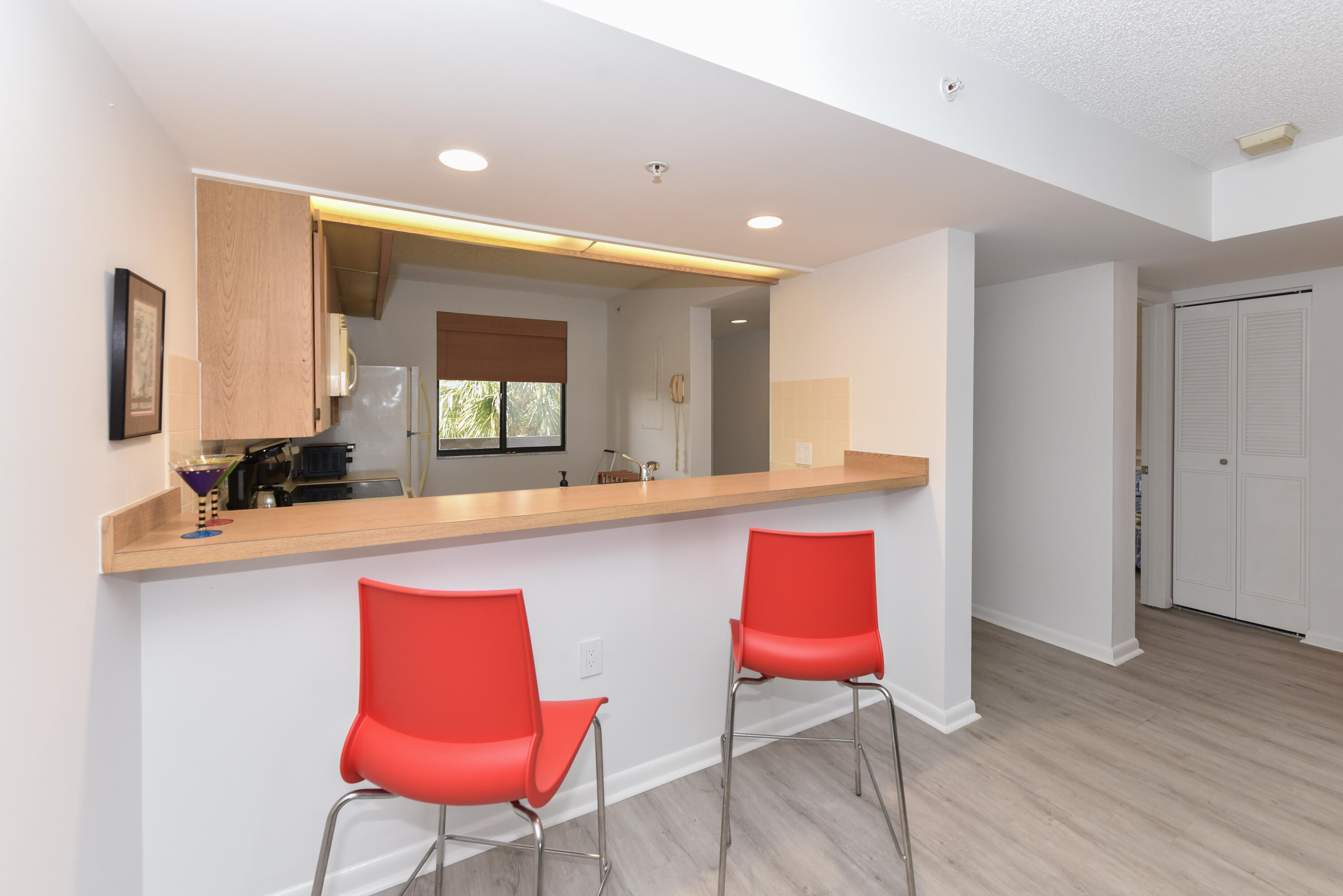 2401 Marina Isle Way, Unit 405 Jupiter, FL 33477 - Photo 10 of 30 a kitchen with stainless steel appliances kitchen island granite countertop a stove a sink and a refrigerator