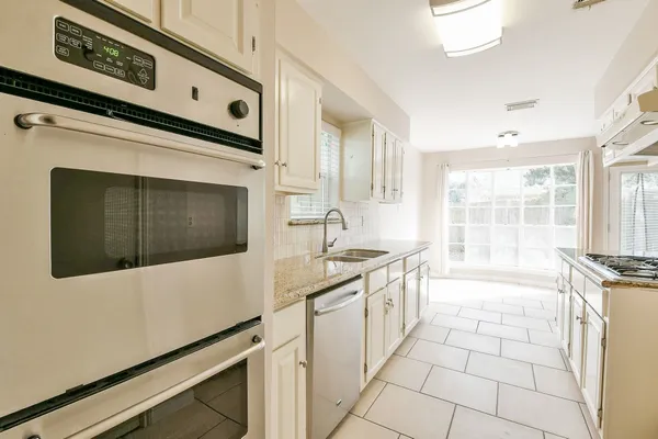 a view of a kitchen with granite countertop cabinets and outdoor space