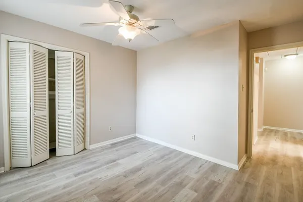a view of a house with a yard and potted plants