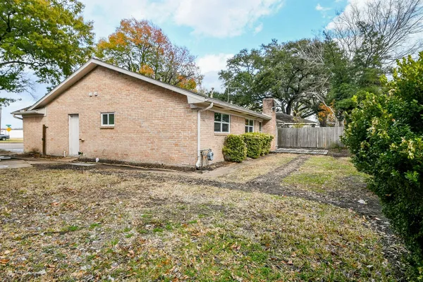 a front view of house with yard and trees around