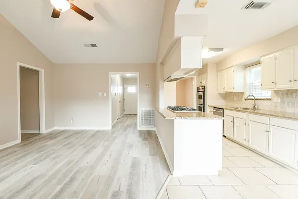 a large white kitchen with a sink