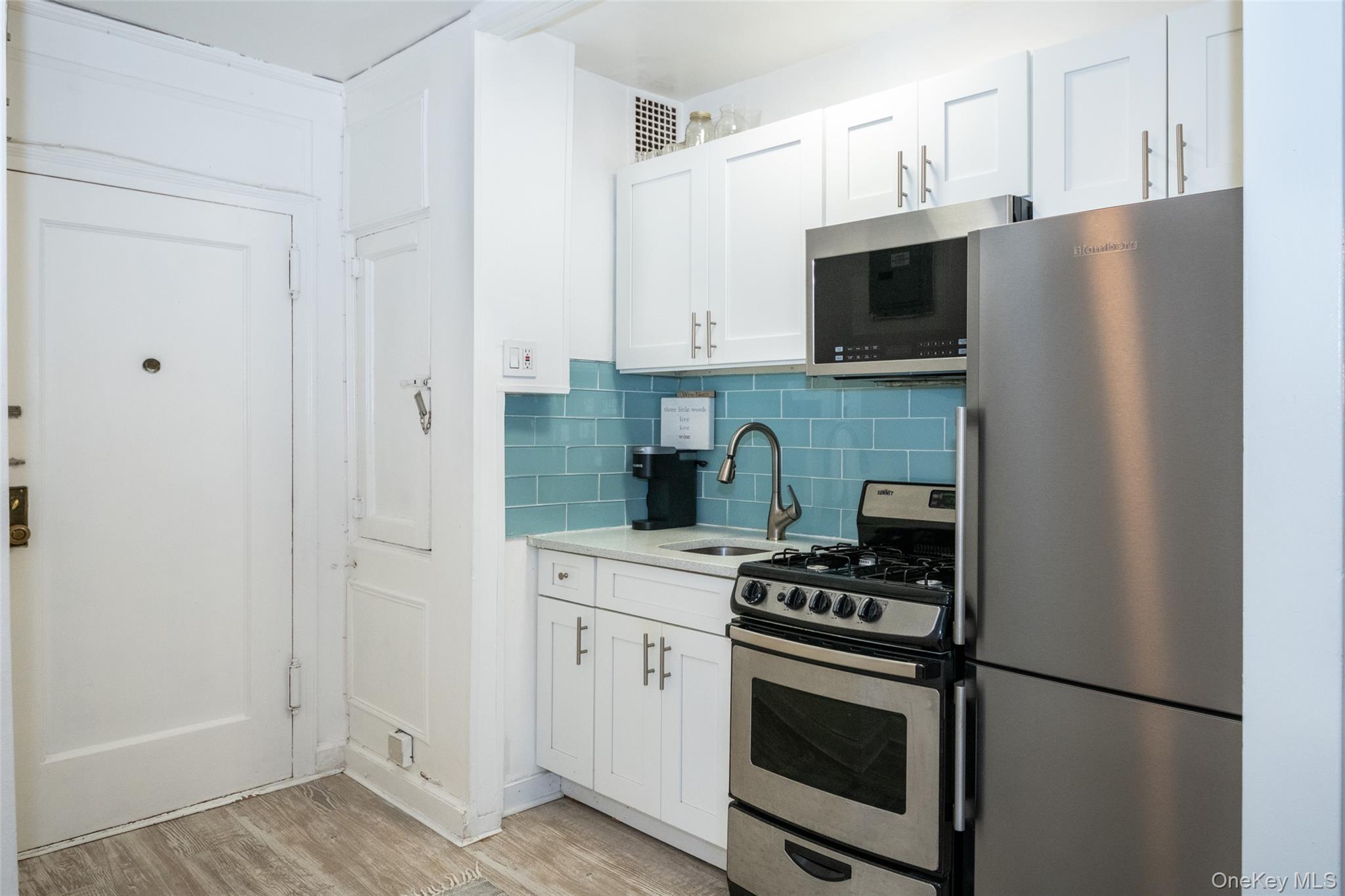 151 Centre Avenue, Unit 5B New Rochelle, NY 10805 - Photo 3 of 14 a kitchen with stainless steel appliances a refrigerator stove and microwave
