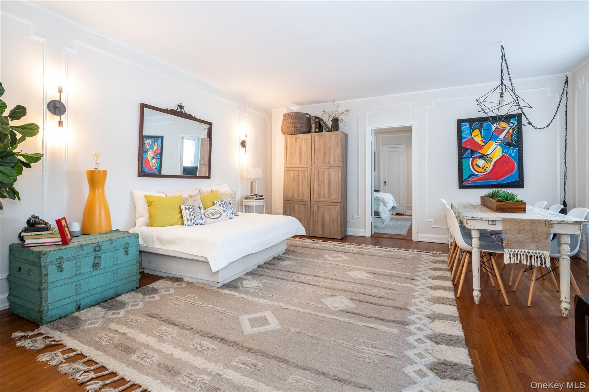 151 Centre Avenue, Unit 5B New Rochelle, NY 10805 - Photo 5 of 14 a bedroom with a bed a couch and painting on the wall