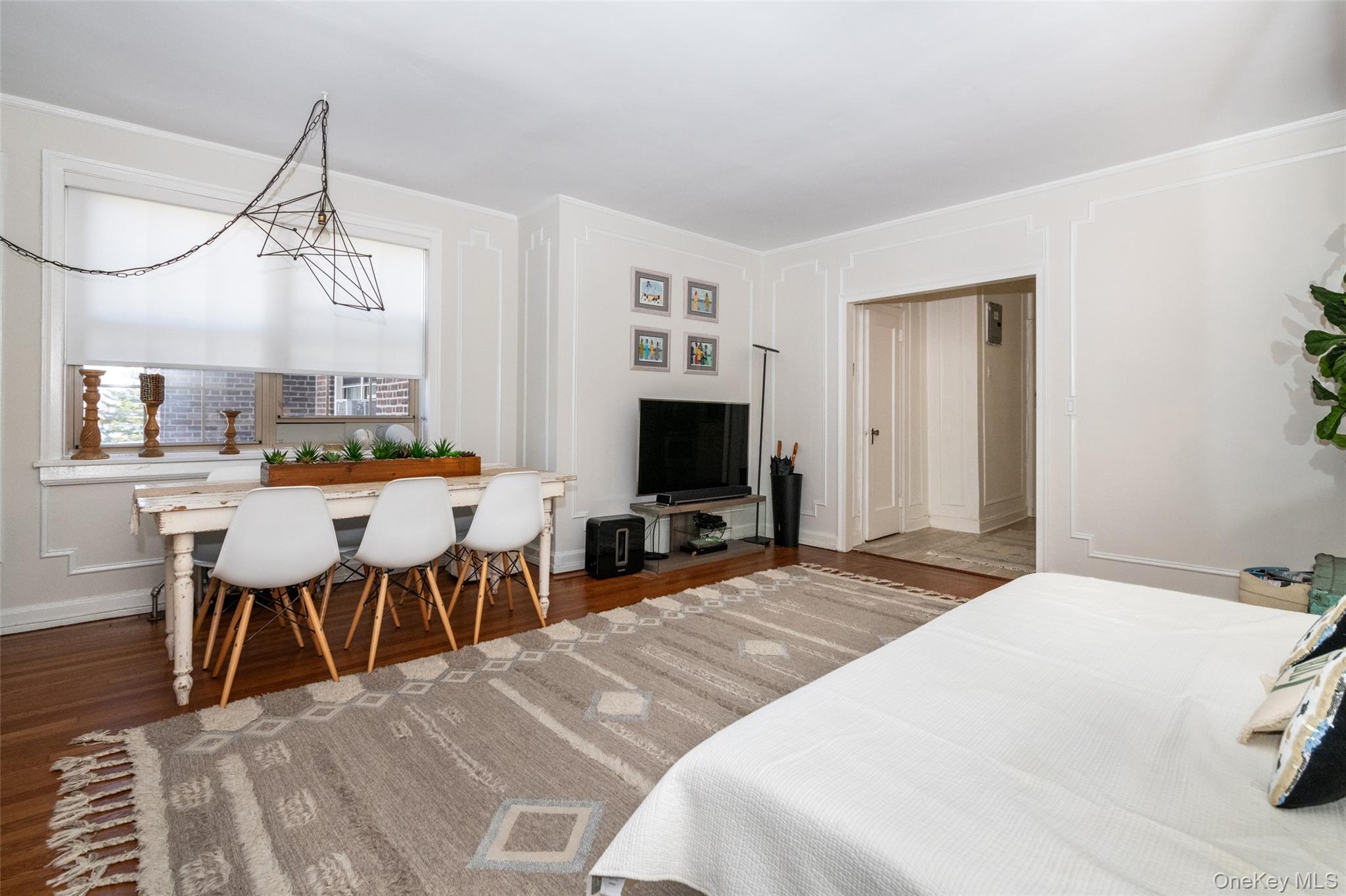 151 Centre Avenue, Unit 5B New Rochelle, NY 10805 - Photo 6 of 14 a large bedroom with a bed and a table in it