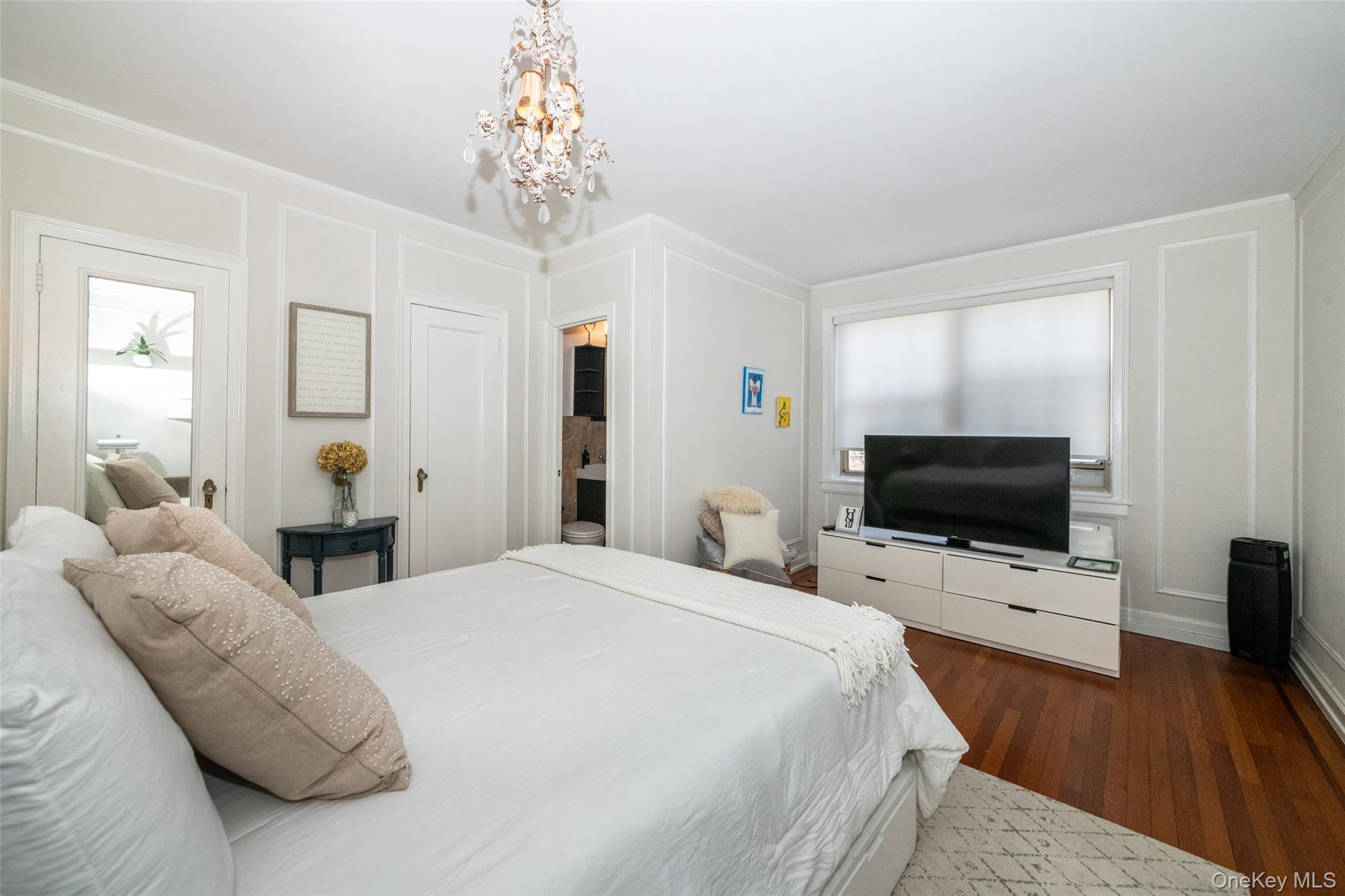 151 Centre Avenue, Unit 5B New Rochelle, NY 10805 - Photo 10 of 14 a bedroom with a bed and a flat tv screen on dresser