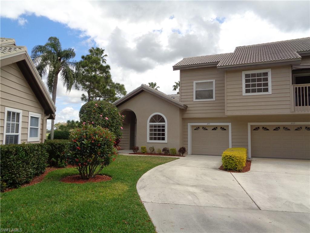 a view of a house with a yard and potted plants