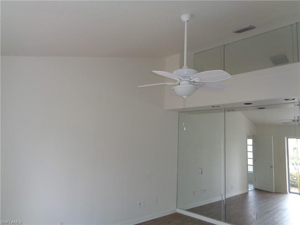 271 Perignon Place, Unit 161 Naples, FL 34119 - Photo 16 of 39 a room with a fan and wooden floor