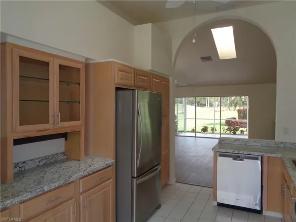 a kitchen with stainless steel appliances granite countertop a refrigerator and a sink