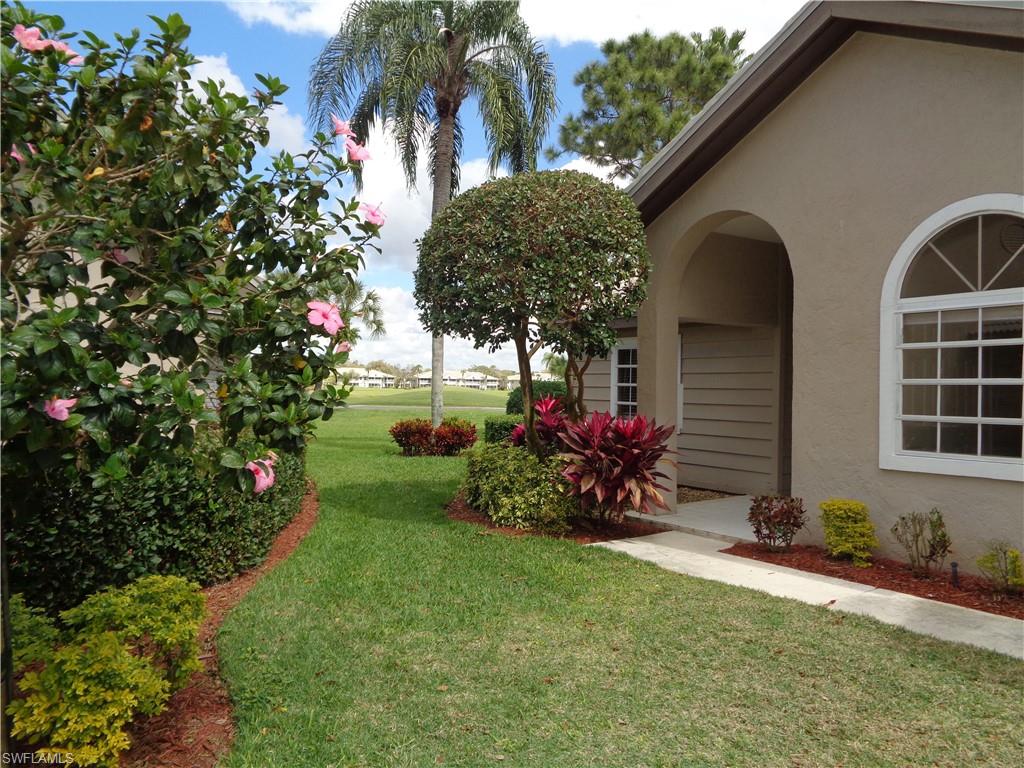 271 Perignon Place, Unit 161 Naples, FL 34119 - Photo 2 of 39 a view of a house with a yard and potted plants