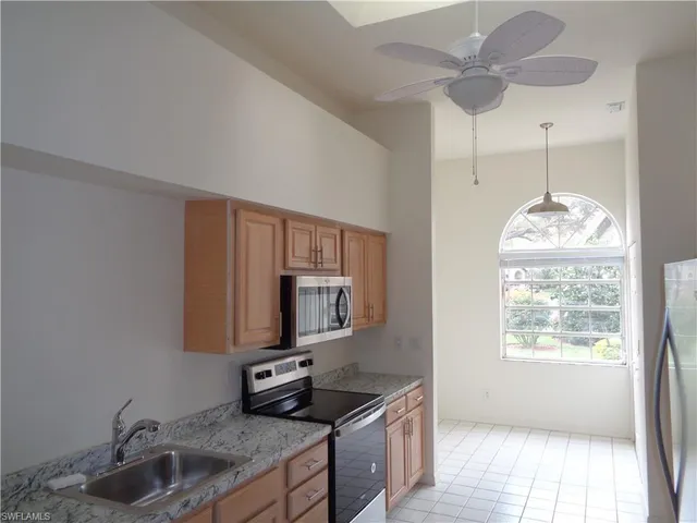 a kitchen with stainless steel appliances granite countertop a sink and a microwave