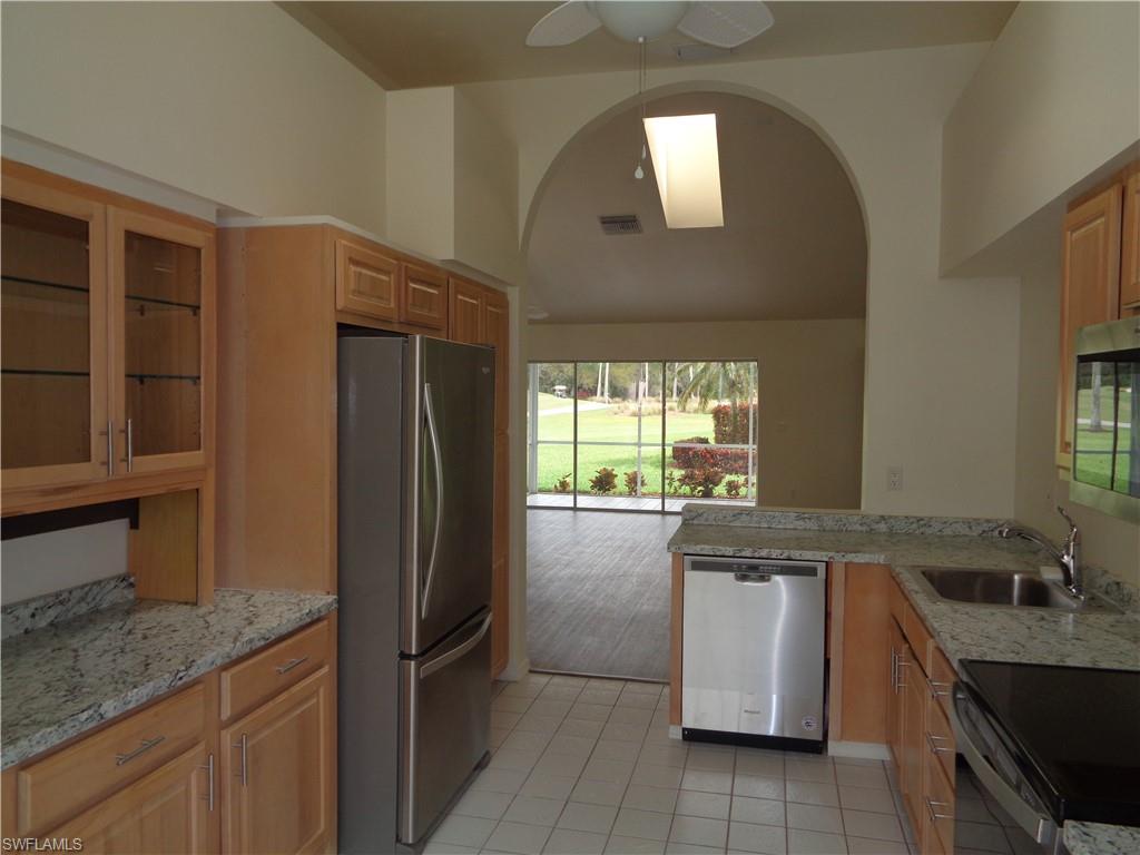 271 Perignon Place, Unit 161 Naples, FL 34119 - Photo 24 of 39 a kitchen with a sink stove and refrigerator