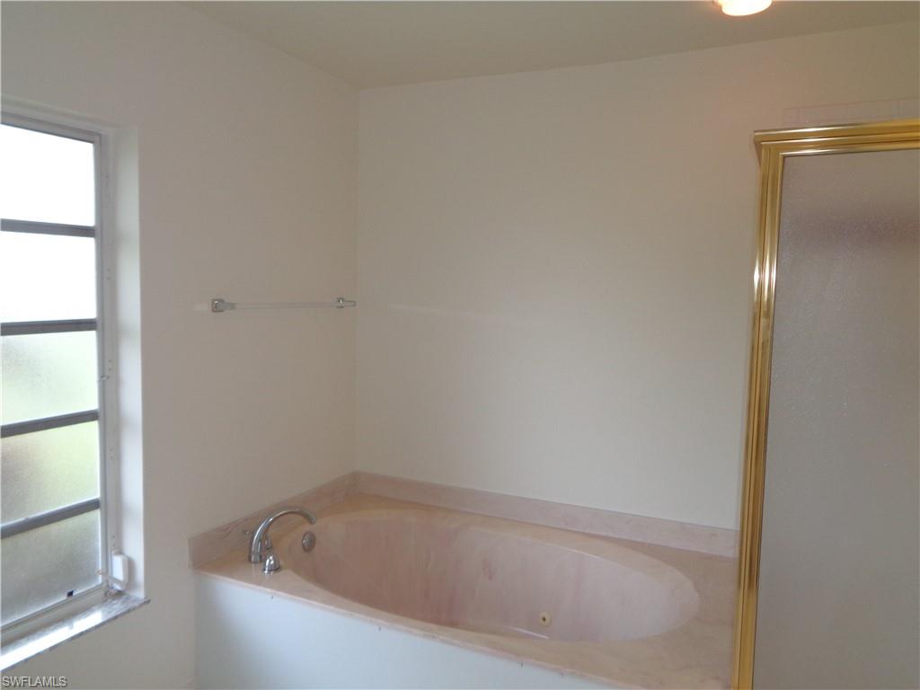 271 Perignon Place, Unit 161 Naples, FL 34119 - Photo 25 of 39 a white bath tub sitting next to a window