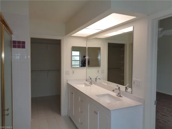 a bathroom with a double vanity sink and mirror