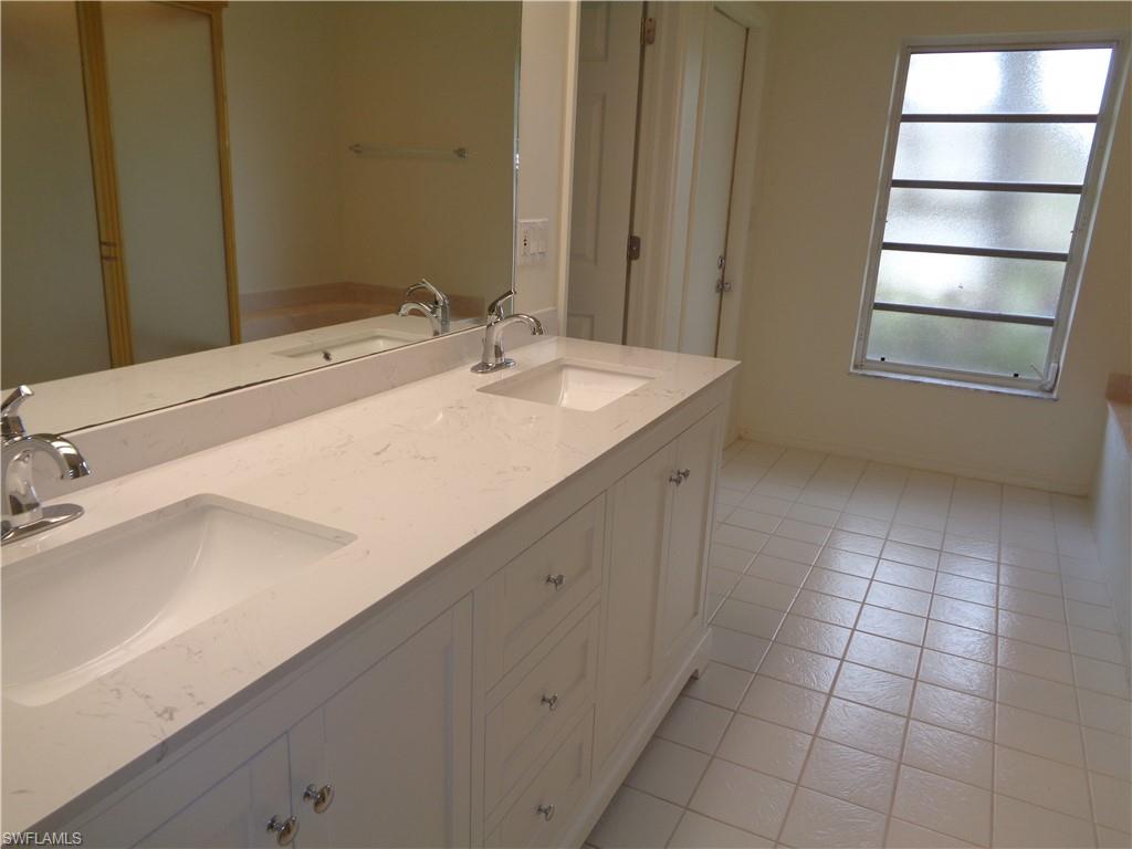 271 Perignon Place, Unit 161 Naples, FL 34119 - Photo 28 of 39 a bathroom with a sink and a mirror