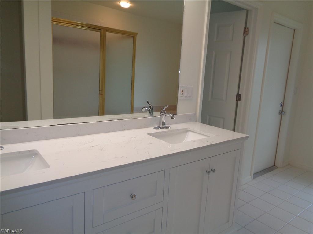 271 Perignon Place, Unit 161 Naples, FL 34119 - Photo 29 of 39 a bathroom with a sink and a mirror