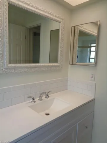 a bathroom with 2 sink and a mirror