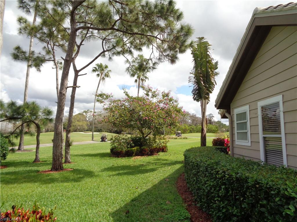 271 Perignon Place, Unit 161 Naples, FL 34119 - Photo 3 of 39 a view of a backyard with large trees