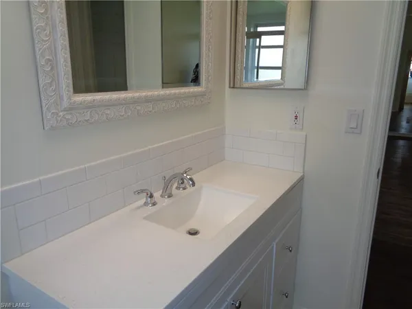 a bathroom with a sink and a mirror