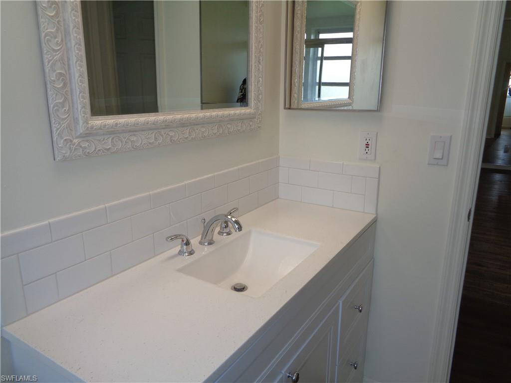 271 Perignon Place, Unit 161 Naples, FL 34119 - Photo 31 of 39 a bathroom with a sink and a mirror