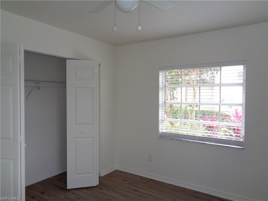 271 Perignon Place, Unit 161 Naples, FL 34119 - Photo 34 of 39 a view of an empty room with wooden floor and a window