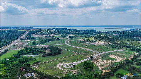 a view of a street with a large trees