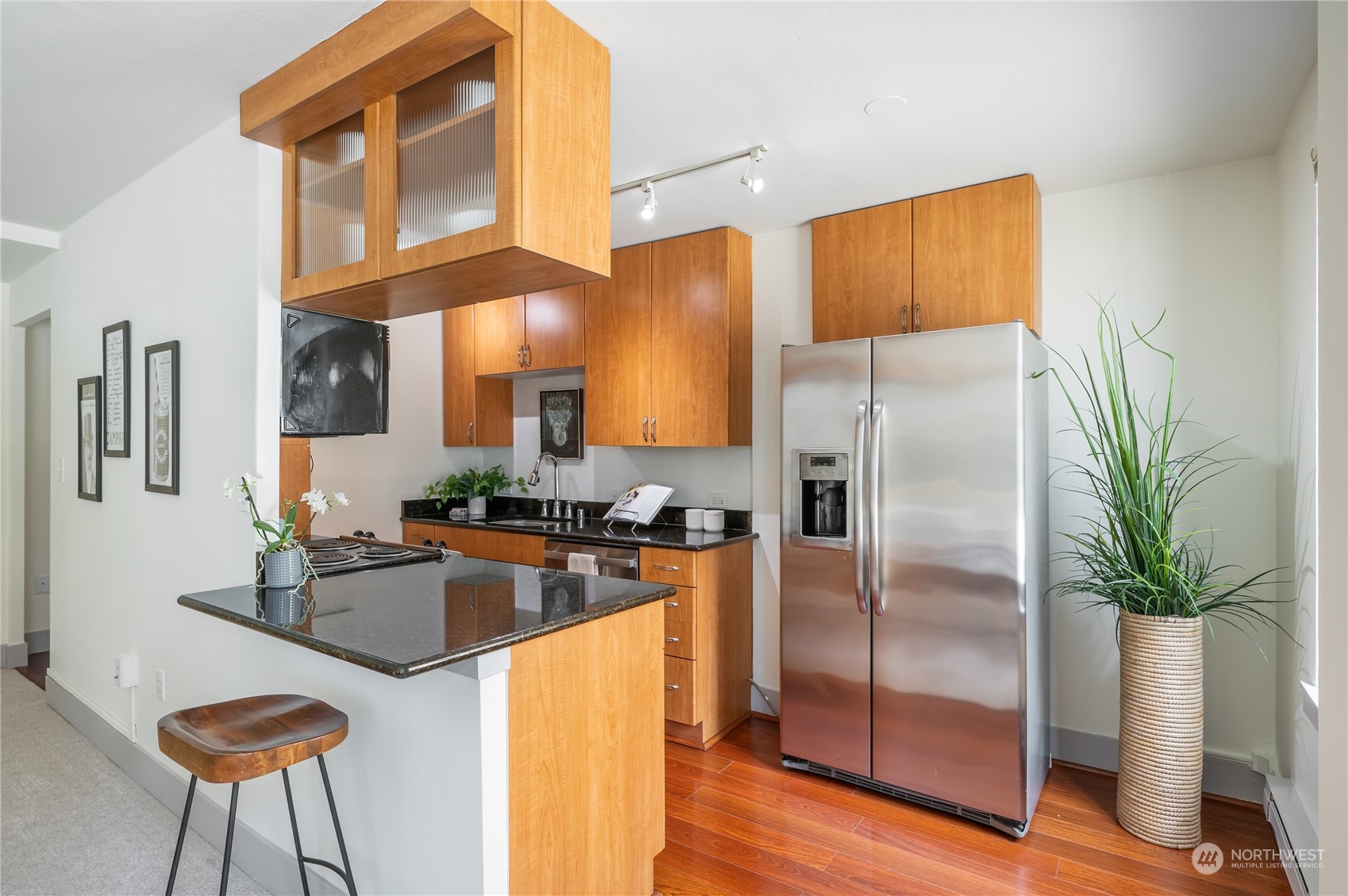 1105 Spring Street, Unit 312 Seattle, WA 98104 - Photo 11 of 26 a kitchen with stainless steel appliances granite countertop a refrigerator a stove and a refrigerator