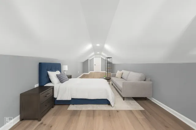 a bedroom with a bed and a night stand