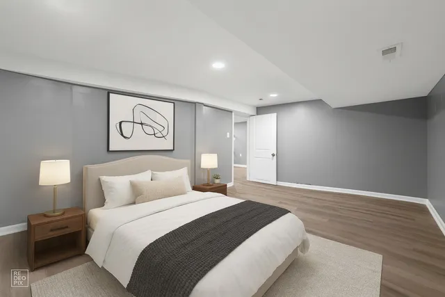 a bedroom with a bed and a lamp