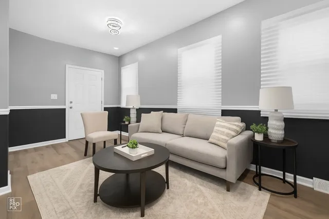 a living room with furniture and wooden floor